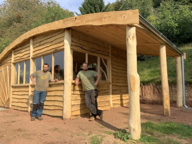 Bryce and Justin with their completed project Sustainably sourced Chestnut, Oak and Larch cladding were used to build this outdoor classroom in Monm