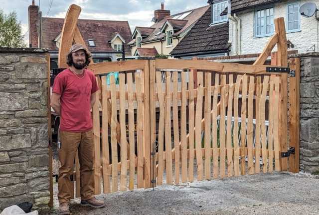 Bryce with an Eardisley Gate - This unique gate was made as a wedding present, so we milled up a forked oak tree, each gate is made from a different half. A (tree) union for a (people) union. Bryce with an Eardisley Gate - This unique gate was made as a wedding present, so we milled up a forked oak tree, each gate is made from a different half. A (tree) union for a (people) union.