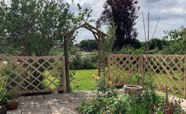 24 Existing arch with Chestnut diamond trellis panels Existing arch with Chestnut diamond trellis panels