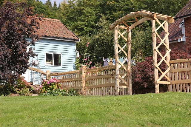023 Mortise framed Cleft Chestnut picket fencing with handrail and rose arch Mortise framed Cleft Chestnut picket fencing with handrail and rose arch