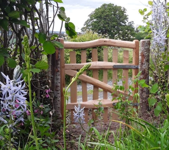 A Harvest gate with bark-on gateposts is perfect in this pretty country garden A Harvest gate with bark-on gateposts is perfect in this pretty country garden