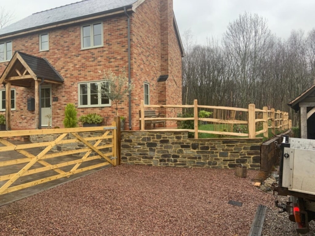 Traditional patterned sawn gate with cleft post and rail fencing Sawn gate with post and rail fencing