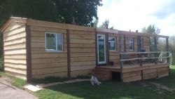 Cladding and a deck turns a static caravan into a log cabin.... Cladding turns a static caravan into a log cabin....