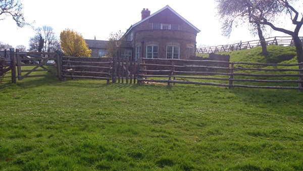 8 Free standing post and rail fence around a house with archaeological restrictions preventing digging 9 Free standing cleft Chestnut post and rail fence around a house with archaeological restrictions preventing digging